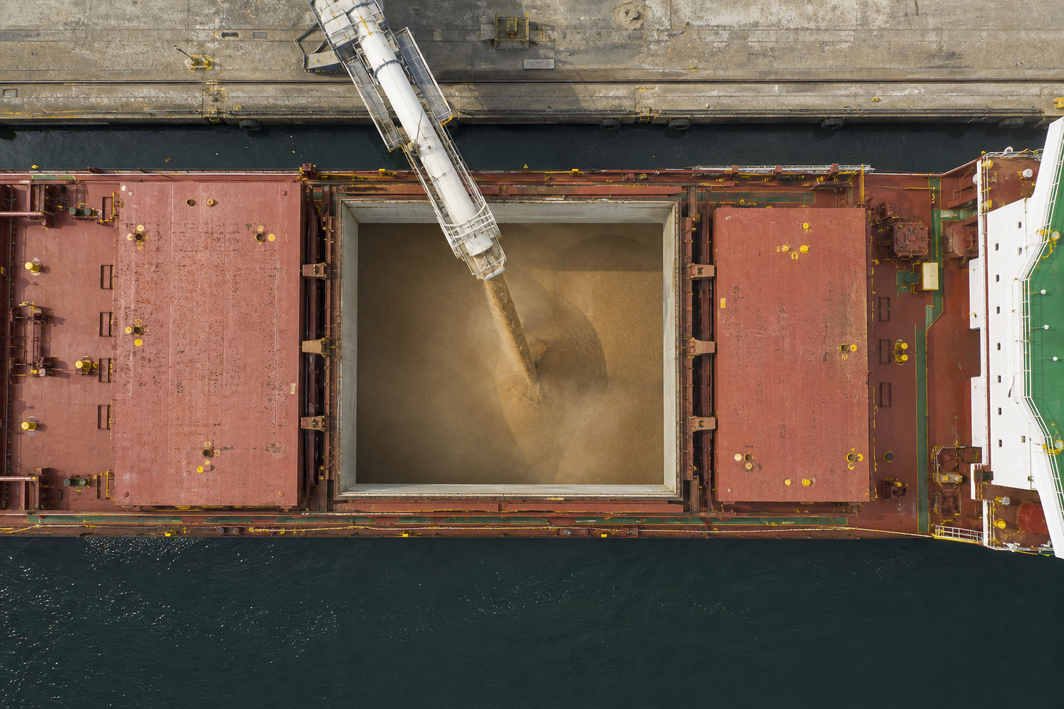 Aerial view of a bulk ship being loaded with grain